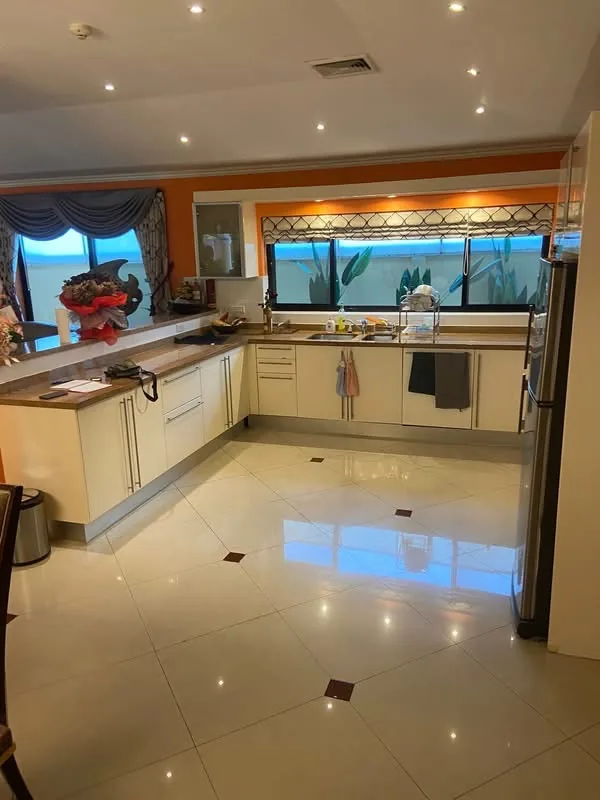 Cream fitted kitchen with a breakfast bar, by Planet Kitchen in Pattaya